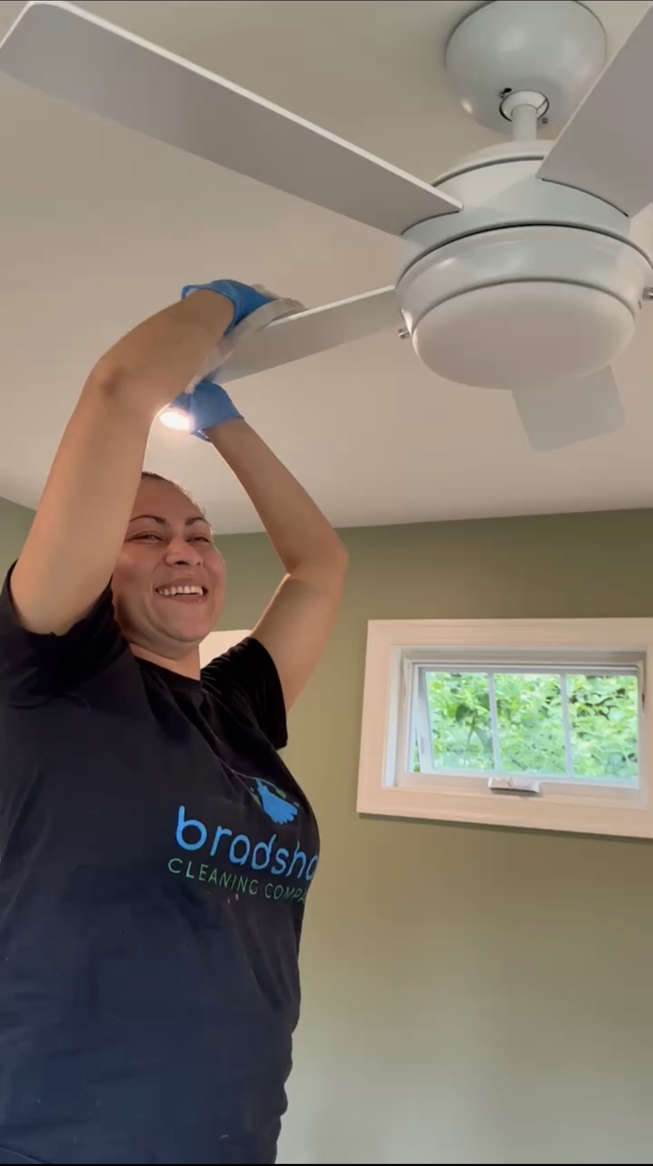 Professional Cleaning Team Member Cleaning a Fan